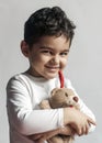 5 years adorable little kid boy playing with plush bear toy