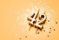 42 years birthday celebration festive background made with golden candle in the form of number Forty two