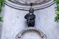 The 400 years Birthday of Famous statue of The Manneken Pis, Brussels, Belgium. Peeing Boy in Suite and Birthday Cake Royalty Free Stock Photo