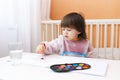 2 years boy with brush and water color paints at home Royalty Free Stock Photo