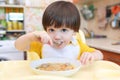 2 years boy eating soup with meat balls at home kitchen Royalty Free Stock Photo