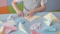 6 years boy makes an origami planes and frogs during quarantine Covid-19