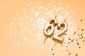 62 years celebration festive background made with golden candles in the form of number Sixty-two