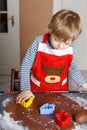 3 years child baking ginger bread cookies for Christmas Royalty Free Stock Photo