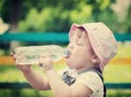 2 years child drinks from plastic bottle