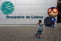 8 Years Child Taking Photos in front of Lisbon Oceanarium Entrance, Nations Park, Portugal
