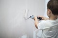 3 years cute little boy painting with roller his room