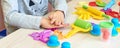 3 years girl creative arts. Child hands playing with colorful clay plasticine. Self-isolation Covid-19, online education, Royalty Free Stock Photo