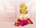 2 years with a Golden balloon. The celebration of the anniversary. Balloons with sparkling confetti fly out of the box, number 2 Royalty Free Stock Photo