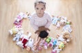 5 years little girl unhappy with lots of toys. Too many toys concept at Infant Behaviour
