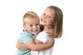 7 years old adorable blond happy girl posing with her little 3 years old brother smiling cheerful isolated on white background Royalty Free Stock Photo