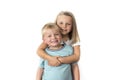 7 years old adorable blond happy girl posing with her little 3 years old brother smiling cheerful isolated on white background Royalty Free Stock Photo