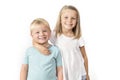 7 years old adorable blond happy girl posing with her little 3 years old brother smiling cheerful isolated on white background Royalty Free Stock Photo