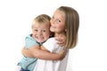 7 years old adorable blond happy girl posing with her little 3 years old brother smiling cheerful isolated on white background Royalty Free Stock Photo