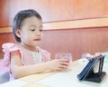 3 years old Asian little girl student online learning class study online in zoom with mobile phone at home Royalty Free Stock Photo