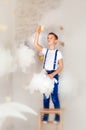 6 years old boy in blue jeans and suspender stand on ladder in clouds and touch star. Dreams come true in childhood. Magic for Royalty Free Stock Photo