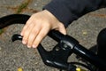 4 years old boy hand on black bicycle grip-brake Royalty Free Stock Photo