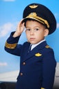 4 years old boy in a pilot suit posing before the plane
