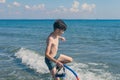 13 years old boy in the snorkeling mask and tube for diving in the sea wave. Travel and summer concept. Royalty Free Stock Photo