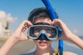 13 years old boy in the snorkeling mask and tube for diving in the sea wave. Travel and summer concept. Royalty Free Stock Photo