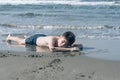 13 years old boy relaxation on the sand on the beach in the sea waves. Concept of family summer vacation Royalty Free Stock Photo