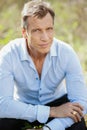 40-50 years old business man in a blue suit posing outdoor