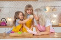 30 years old caucasian mother helping her cute litte daughters cooking together