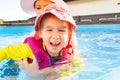 2-3 years old child with mother in swimming pool learn to swim. Summer at home concept