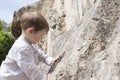 3 years old child touching the rock surface