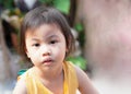 4 years old cute baby Asian girl looking to camera. Absent minded children Royalty Free Stock Photo