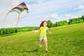 6 years old girl running with kite