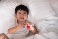 3 years old little cute Asian boy at home on the bed, kid lying Royalty Free Stock Photo