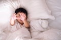 3 years old little cute Asian boy at home on the bed, kid lying Royalty Free Stock Photo