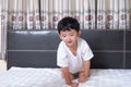 3 years old little cute Asian boy at home on the bed, kid lying Royalty Free Stock Photo