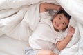 3 years old little cute Asian boy at home on the bed, kid lying Royalty Free Stock Photo