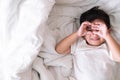 3 years old little cute Asian boy at home on the bed, kid lying Royalty Free Stock Photo