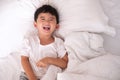 3 years old little cute Asian boy at home on the bed, kid lying Royalty Free Stock Photo