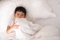 3 years old little cute Asian boy at home on the bed, kid lying Royalty Free Stock Photo