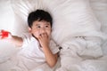 3 years old little cute Asian boy at home on the bed, kid lying Royalty Free Stock Photo