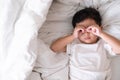 3 years old little sick or illness Asian boy at home on the bed, sad kid laying resting on white bed with pillow and blanket, top Royalty Free Stock Photo