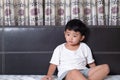 3 years old little sick or illness Asian boy at home on the bed, sad kid laying resting on white bed with pillow and blanket, top Royalty Free Stock Photo