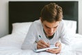 16 years old teenage boy writing school notes or doing homework Royalty Free Stock Photo