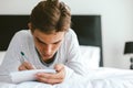 16 years old teenage boy writing school notes or doing homework Royalty Free Stock Photo