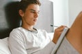 16 years old teenage boy writing school notes or doing homework Royalty Free Stock Photo