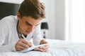 16 years old teenage boy writing school notes or doing homework Royalty Free Stock Photo