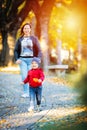 2 years old toddler have fun outdoor in autumn yellow park