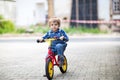 3 years old toddler riding on his first bike