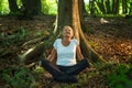 50 years old woman enjoys forest bathing with all her senses. Shinrin Yoku Royalty Free Stock Photo