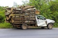 Dilapidated pickup truck carrying logs in thailand