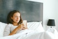 12-14 years teenag girl using smartphone in bed Royalty Free Stock Photo